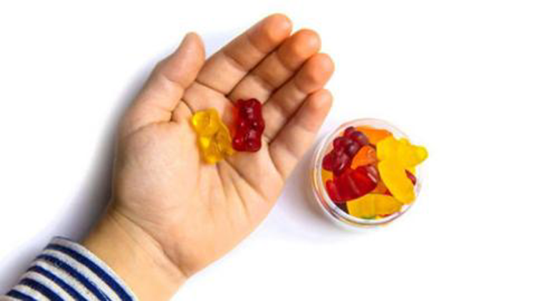 An image of a hand holding the required amount of vitamins 