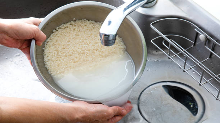 A person filtering rice water: rice water has been said to have some skincare benefits