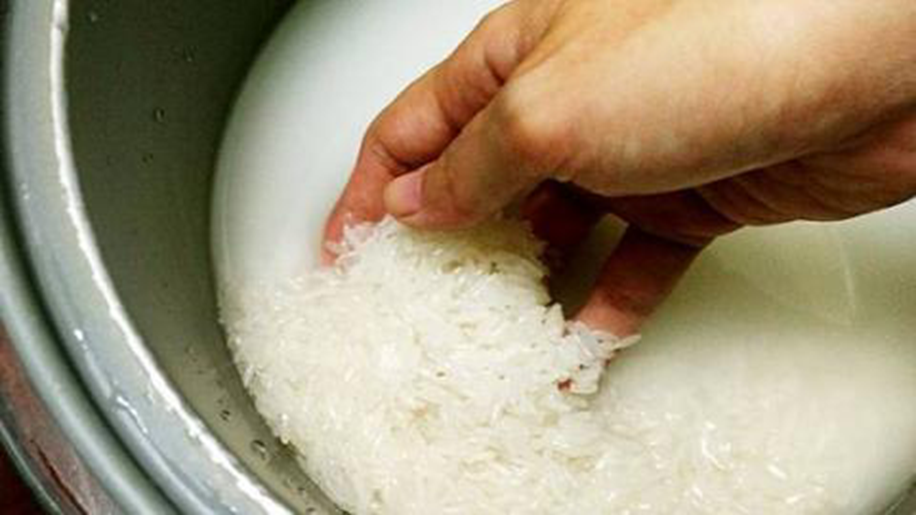 Holding white rice in a bowl